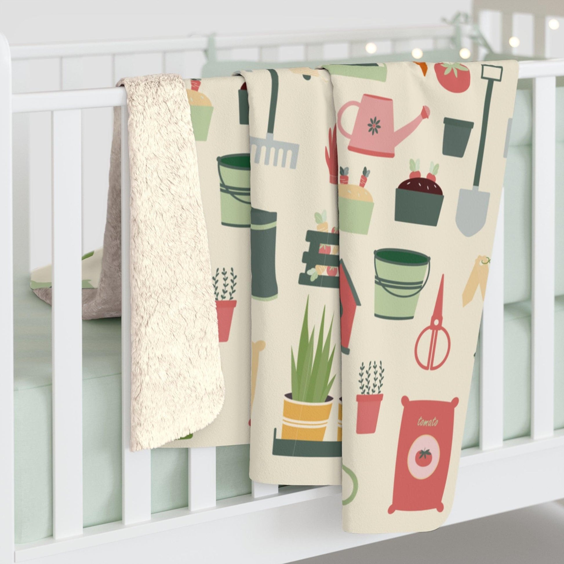 gardeners blanket with tools on it on baby crib