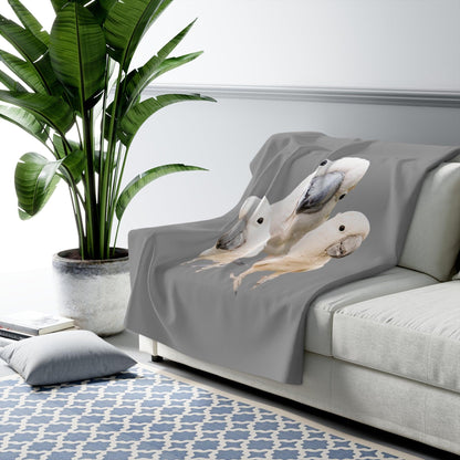 Cockatoo Sherpa Fleece Blanket on couch