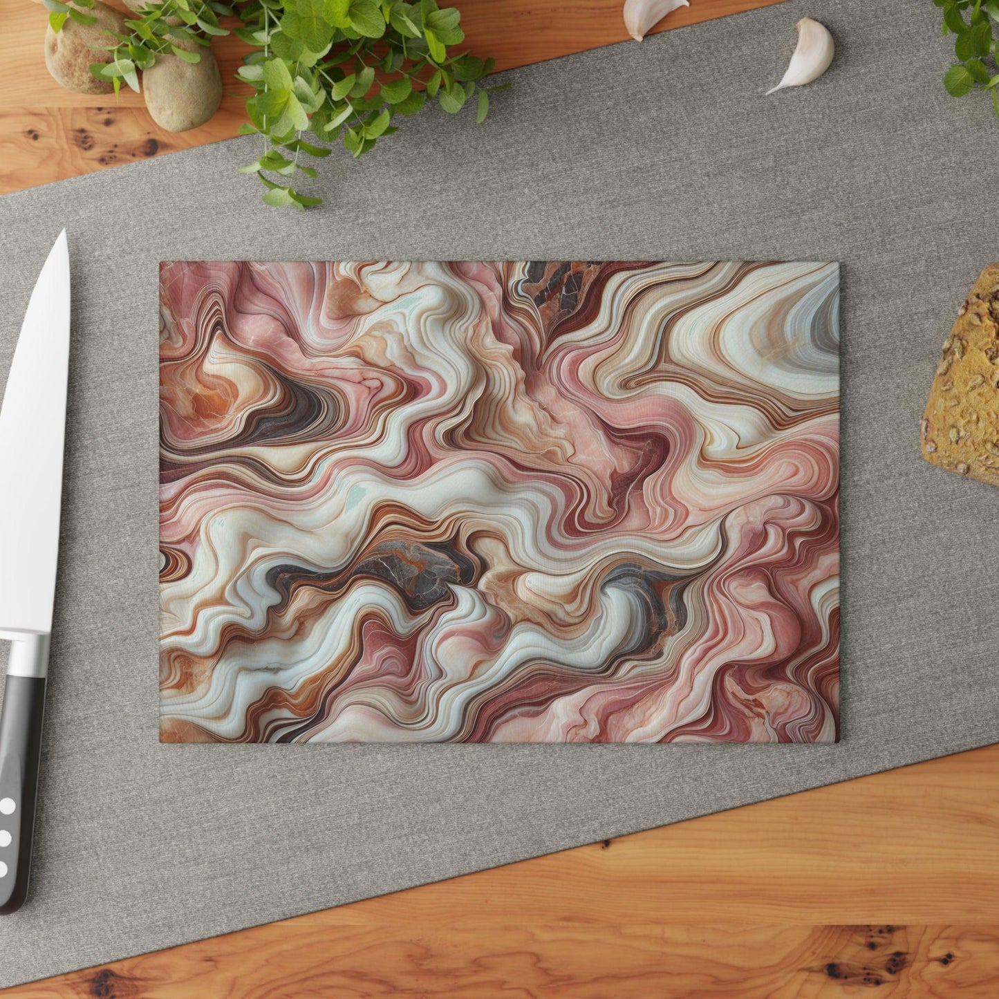 Marble Look Glass Cutting Board Pinks Grays and Browns  on table