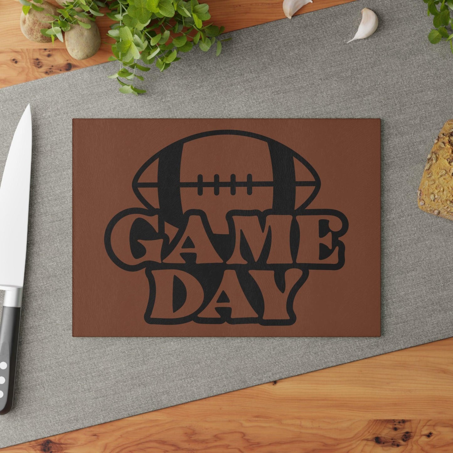 Game Day Football Glass Cutting Board sitting on kitchen table