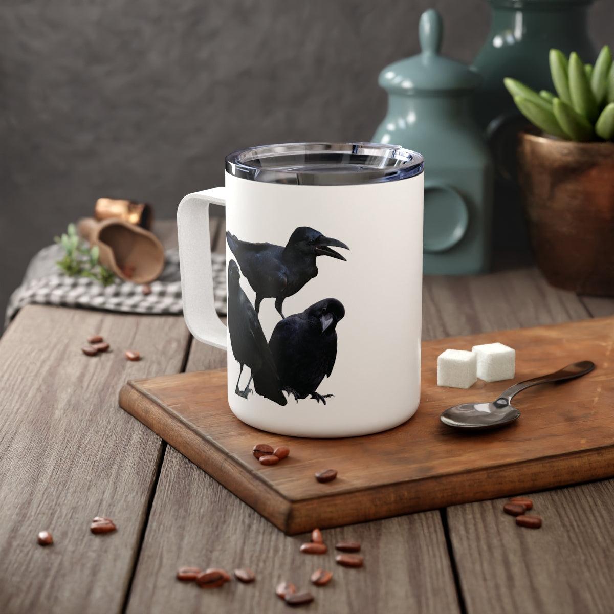 crow insulated coffee mug on table