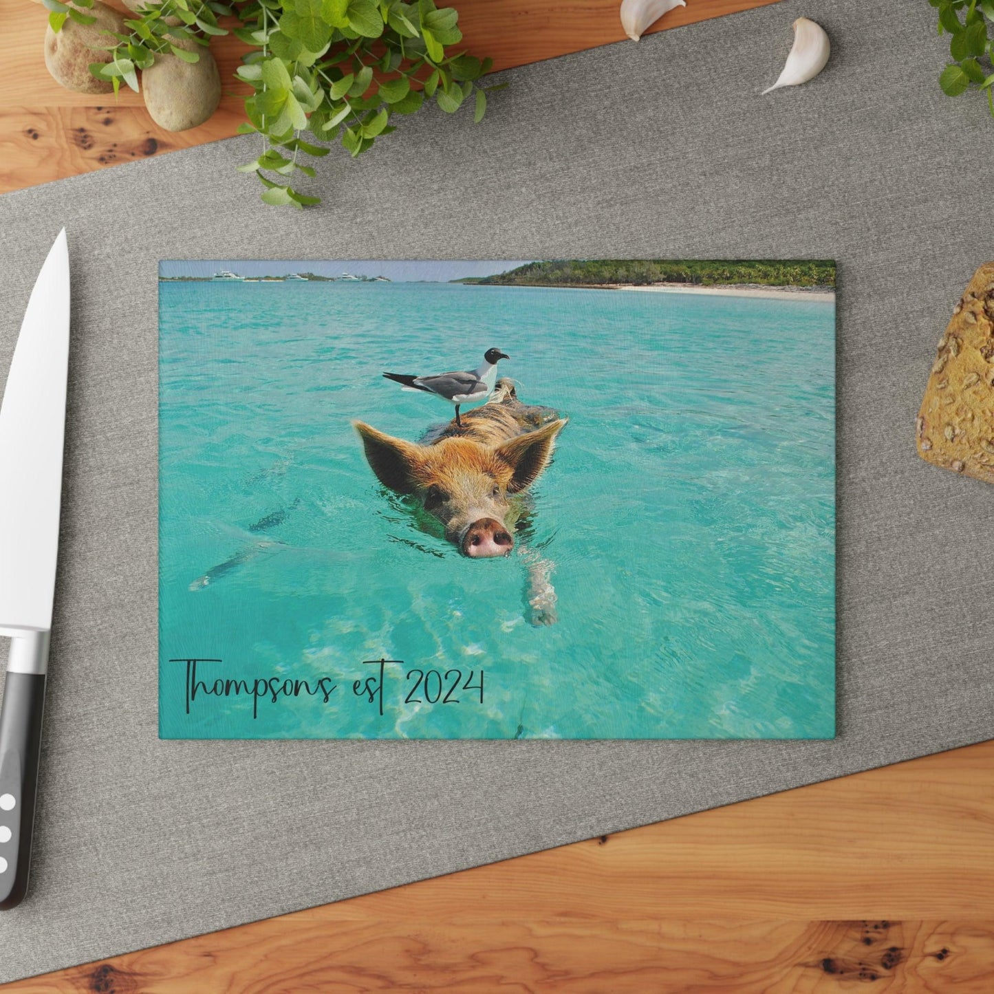 Pig and Bird Swimming in the Ocean Glass Cutting Board table shot