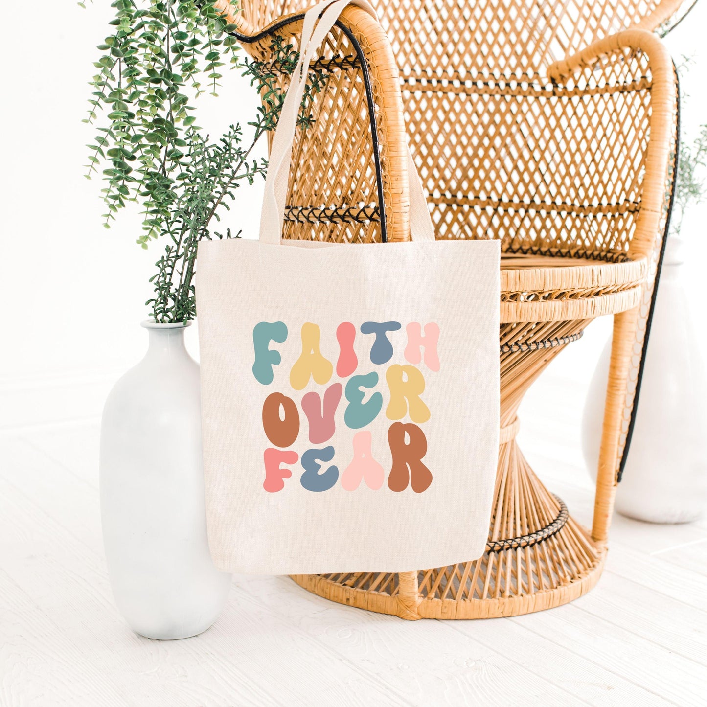 Faith Over Fear Canvas Tote Bag on chair