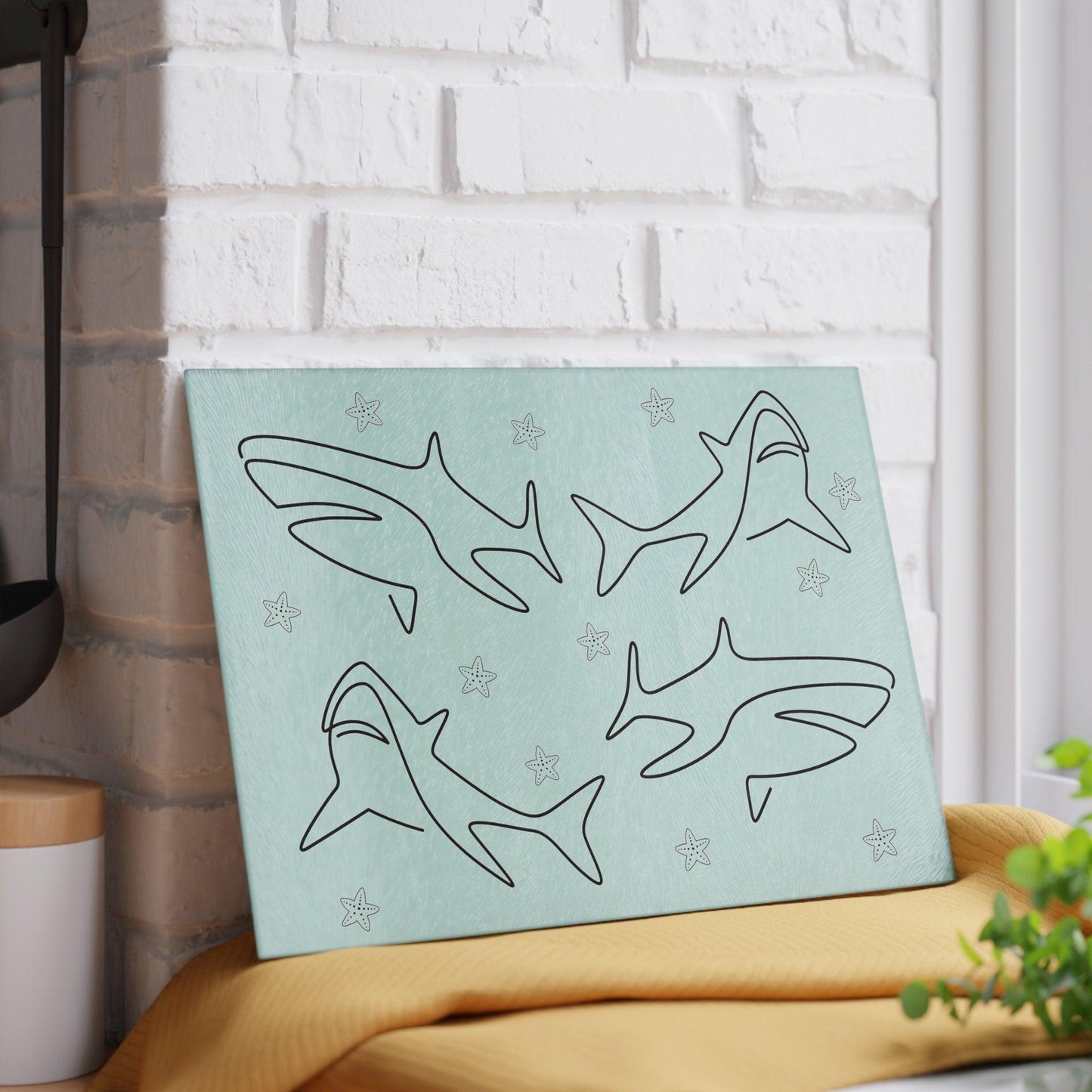 Shark and Starfish Line Art Glass Cutting Board against wall